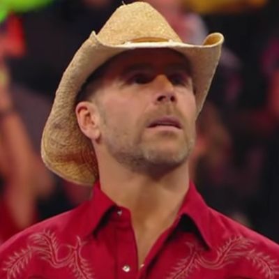 Shawn Michaels is wearing a cowboy hat as he looks onto the crowd.